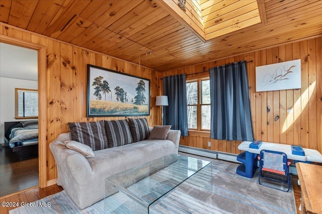 living room with baseboard heating, a skylight, wood ceiling, wooden walls, and hardwood / wood-style floors