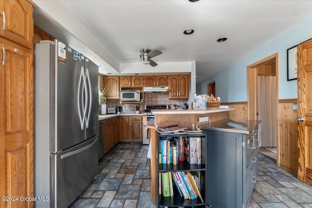 kitchen featuring ceiling fan, stainless steel appliances, backsplash, and tile floors