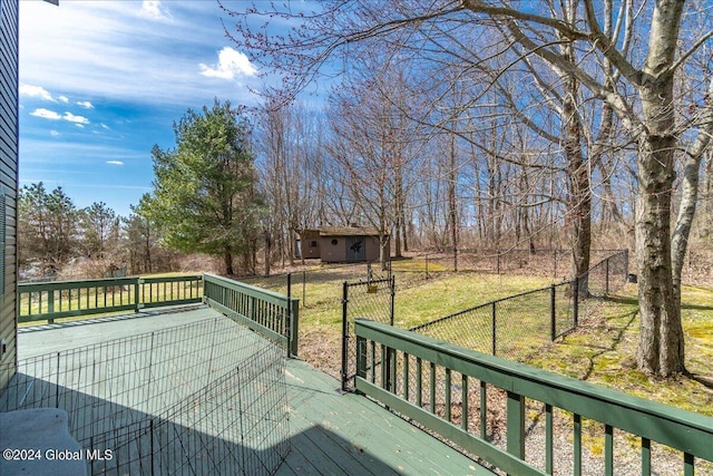 wooden terrace featuring a yard