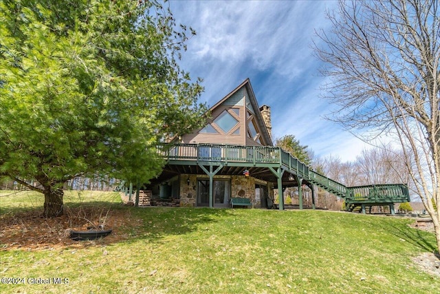 exterior space featuring a deck and a front lawn