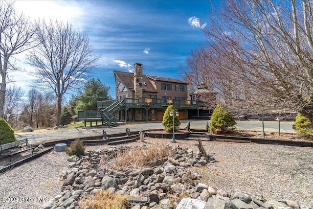 back of house with a wooden deck