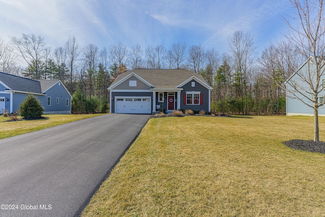 view of front facade with aphalt driveway, a garage, board and batten siding, and a front yard