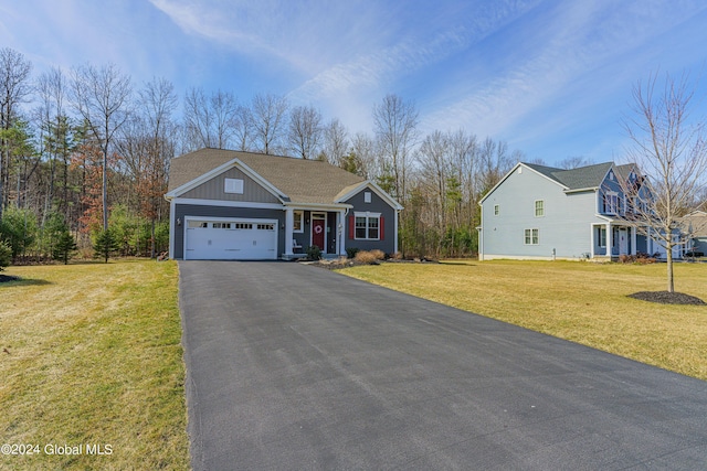 view of front of home with aphalt driveway, board and batten siding, an attached garage, and a front yard