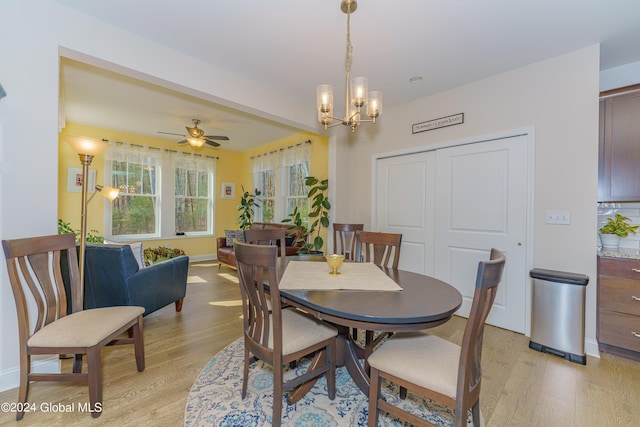 dining area with light wood-style flooring, baseboards, and ceiling fan