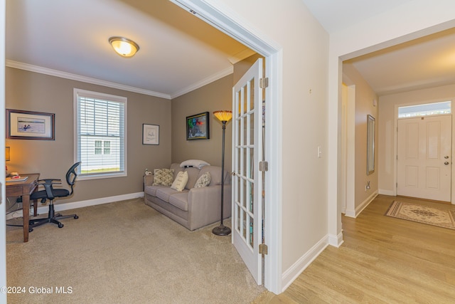 office area featuring light wood-style flooring, light colored carpet, baseboards, and ornamental molding