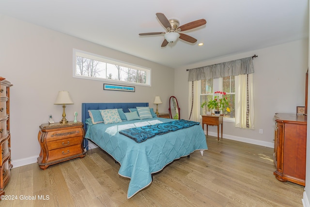 bedroom with light wood finished floors, recessed lighting, baseboards, and ceiling fan