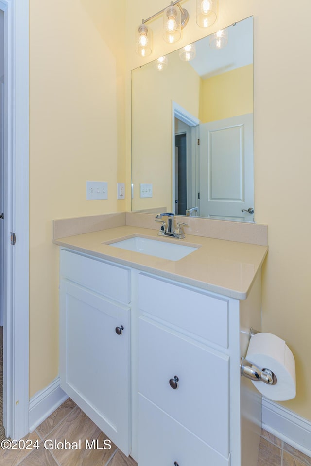 bathroom with vanity and baseboards