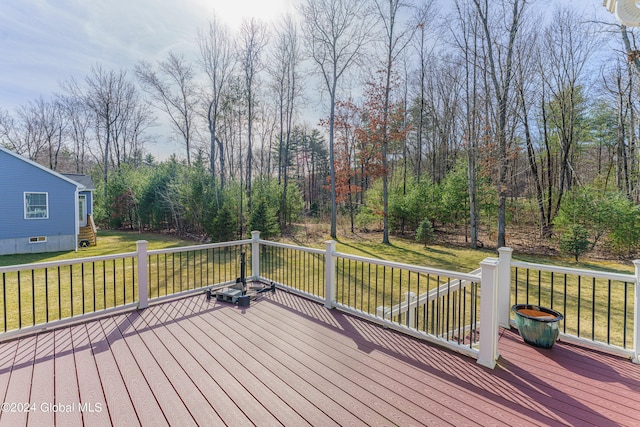 wooden deck featuring a lawn