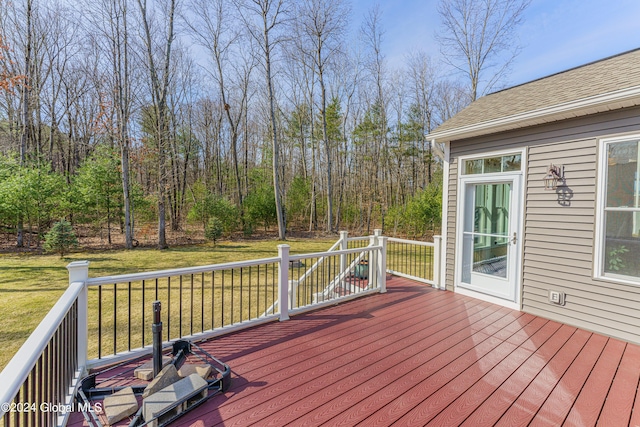 wooden terrace featuring a yard