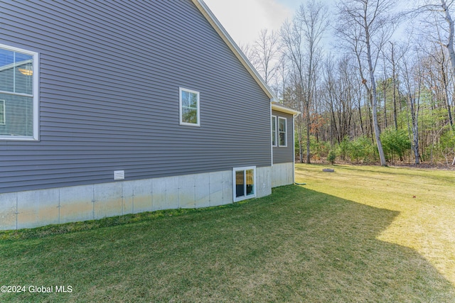 view of side of home featuring a lawn