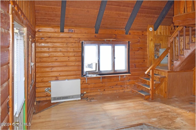 interior space with heating unit, lofted ceiling with beams, wood-type flooring, rustic walls, and wooden ceiling