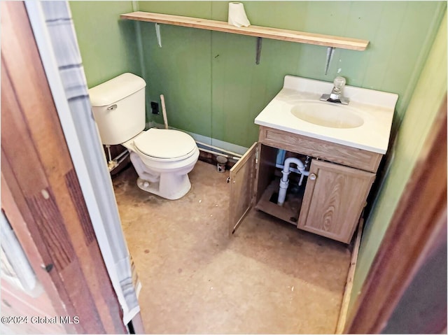 bathroom with toilet, vanity, and concrete flooring