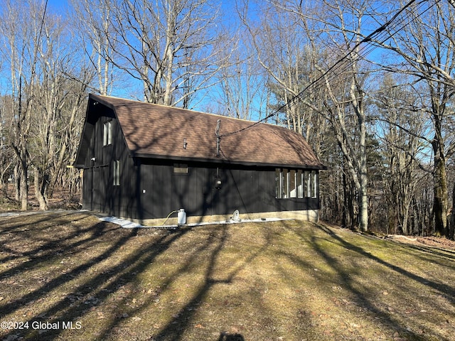 view of side of home featuring a yard