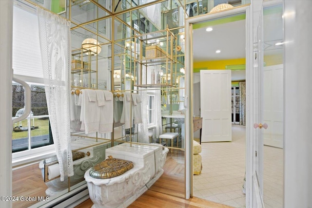 bathroom featuring an inviting chandelier and parquet floors