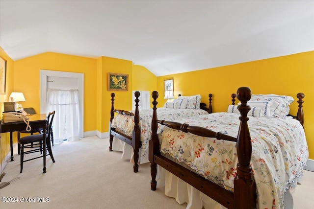 carpeted bedroom with vaulted ceiling