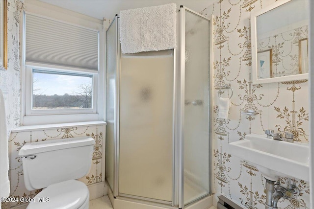 bathroom with toilet and an enclosed shower