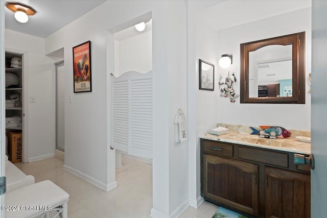 bathroom with vanity, tile flooring, and walk in shower