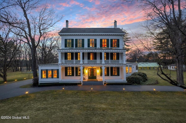 view of front of property with a lawn and covered porch