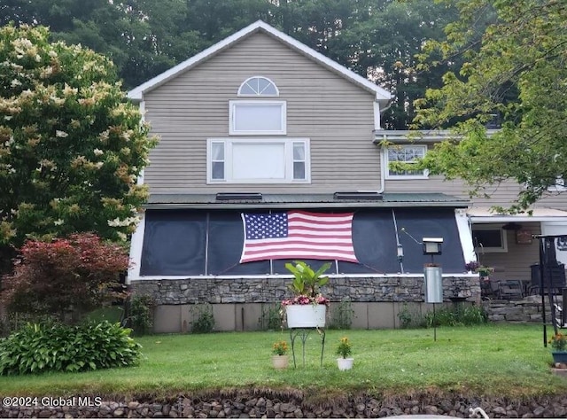 back of house with a lawn