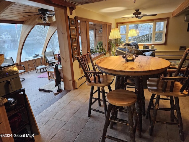 tiled dining room featuring a baseboard radiator and ceiling fan