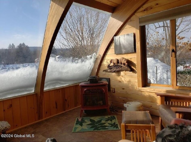 sunroom / solarium featuring a wood stove