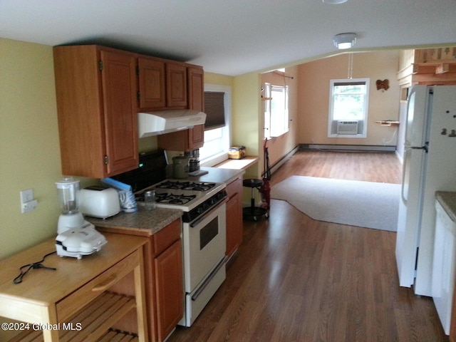 kitchen with dark hardwood / wood-style flooring, white appliances, wall chimney range hood, and vaulted ceiling