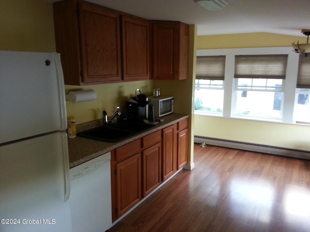 kitchen featuring dark hardwood / wood-style floors, white appliances, a baseboard heating unit, and sink