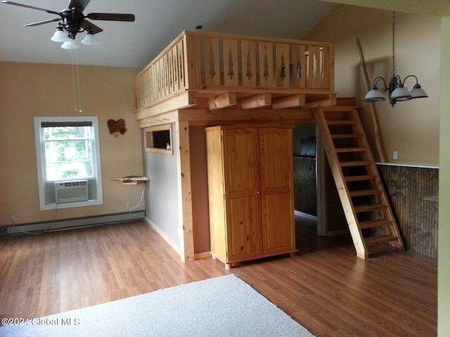 unfurnished bedroom with a baseboard heating unit, lofted ceiling, light hardwood / wood-style flooring, and a chandelier