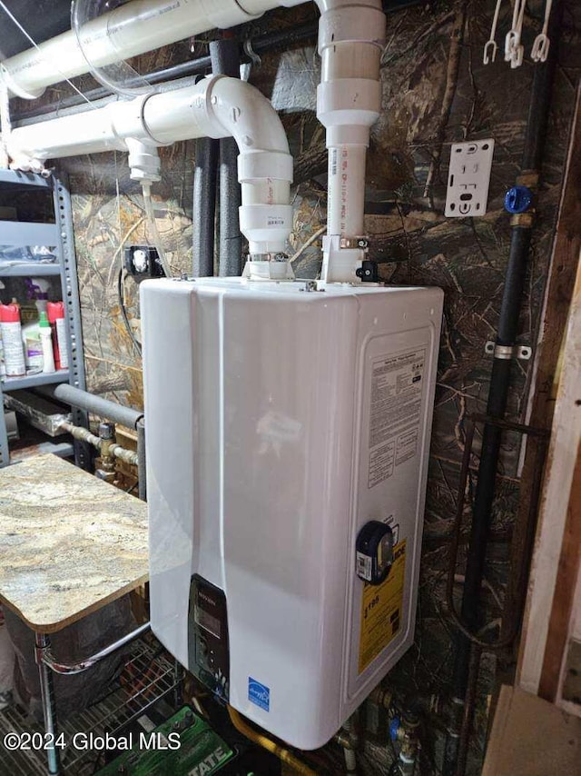 utility room featuring water heater