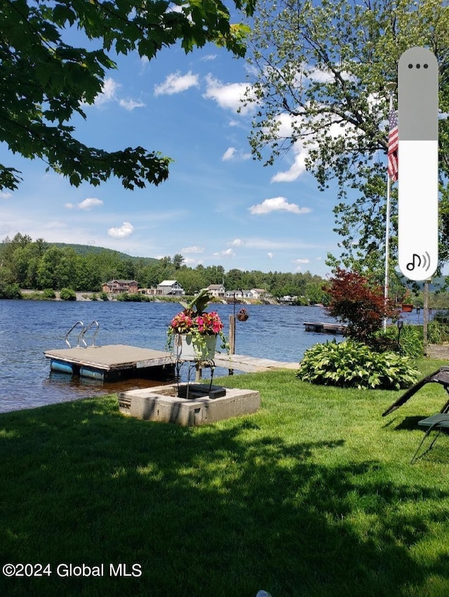 dock area with a water view and a lawn