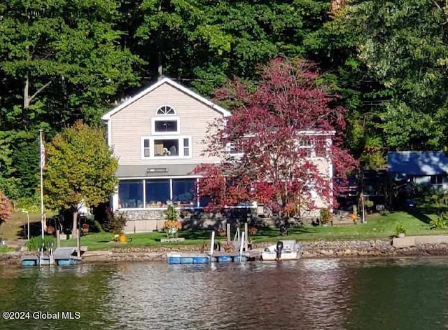 exterior space featuring a water view and a yard