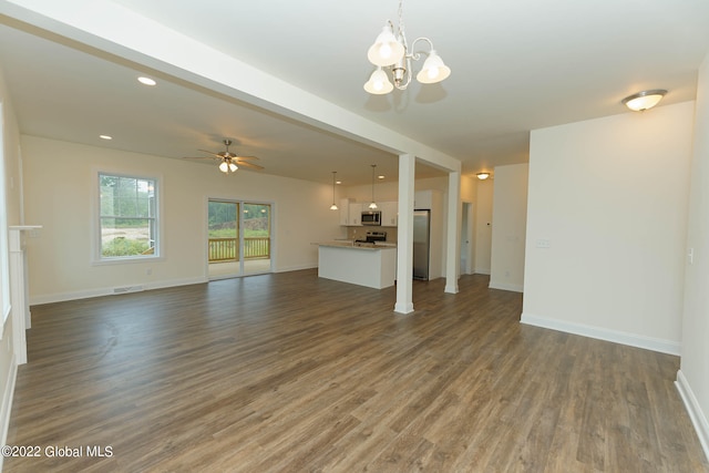 unfurnished living room with dark wood-type flooring and ceiling fan with notable chandelier