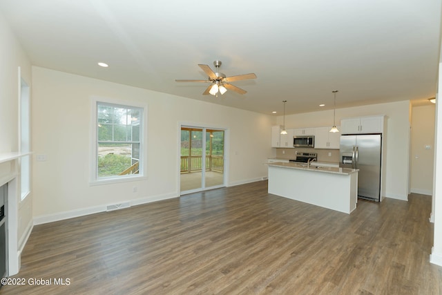 unfurnished living room with dark wood-type flooring and ceiling fan