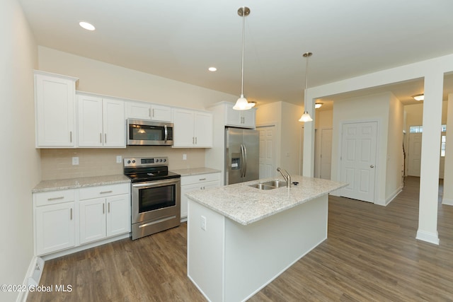 kitchen featuring stainless steel appliances, white cabinetry, sink, decorative light fixtures, and dark wood-type flooring