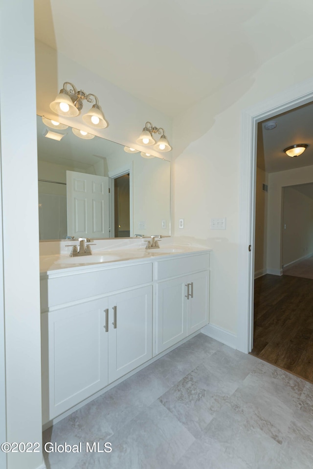 bathroom with vanity and wood-type flooring