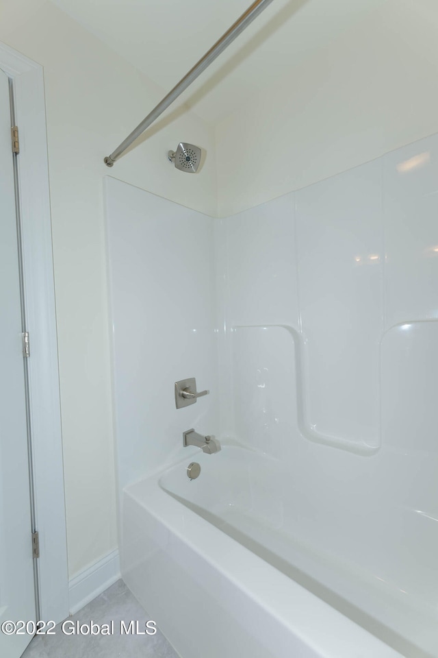 bathroom with tile patterned floors and shower / bath combination