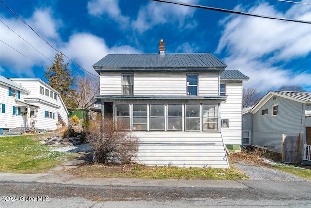 view of front of property featuring a sunroom