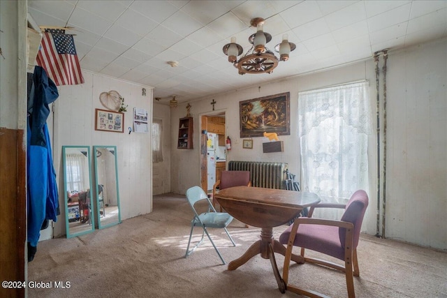 carpeted office with a notable chandelier and radiator heating unit