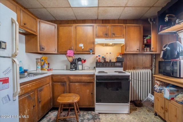 kitchen featuring white appliances, a paneled ceiling, and radiator