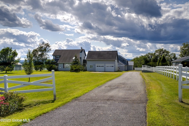 cape cod house featuring a front yard and a garage