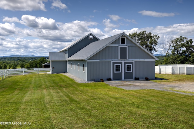 view of side of property with a lawn