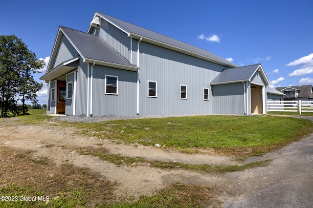 rear view of property featuring a yard