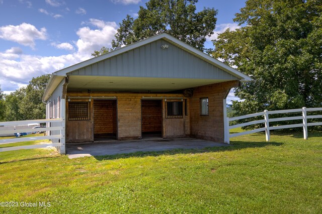 rear view of property featuring a lawn