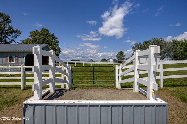 view of gate with a lawn