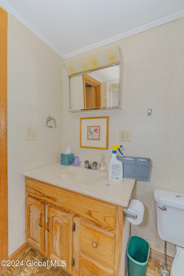 bathroom with parquet flooring, vanity, toilet, and crown molding