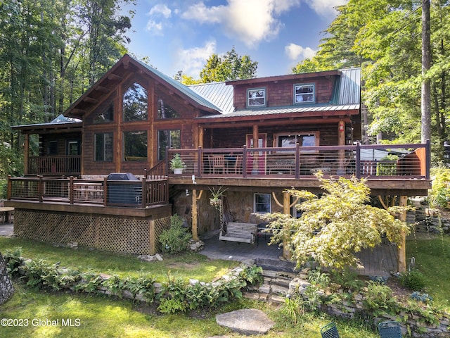 rear view of property with a deck