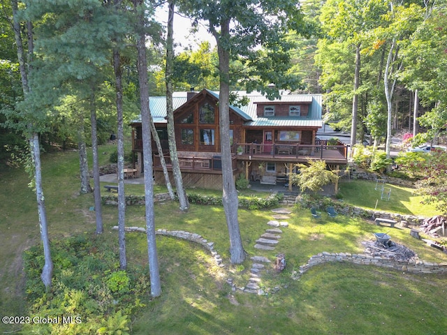 exterior space with a wooden deck and a yard