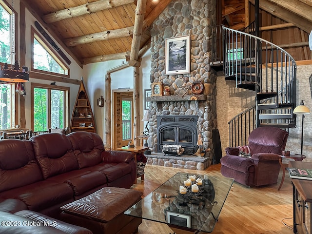 living room featuring wooden ceiling, a wealth of natural light, high vaulted ceiling, a fireplace, and beam ceiling