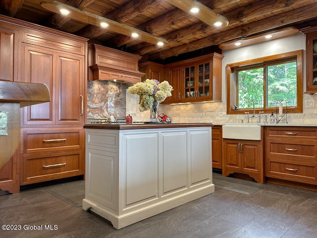 kitchen with wood ceiling, tasteful backsplash, sink, and beamed ceiling