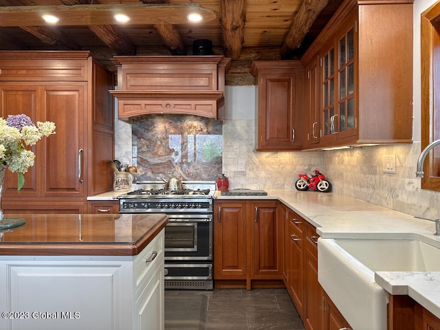 kitchen with tasteful backsplash, beamed ceiling, dark tile flooring, wood ceiling, and double oven range